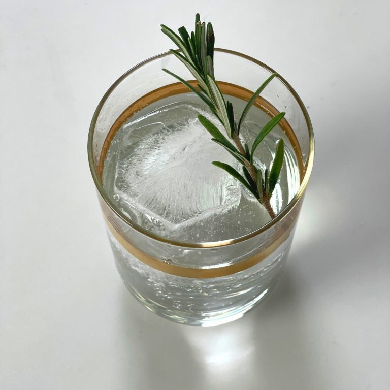 DrinksPlinks Shape Statement Hexagon in gold rimmed glass with rosemary