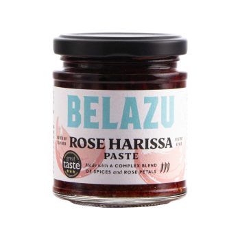 Belazu Rose Harissa paste jar with the lid on a white background.