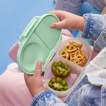 B.Box Snackbox Spearmint lifestyle image with Kiwifruit in one compartment and pretzels in the other.