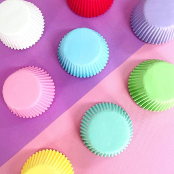 Stacks of the 408 Baking Cup in various colours on a pink and purple background.