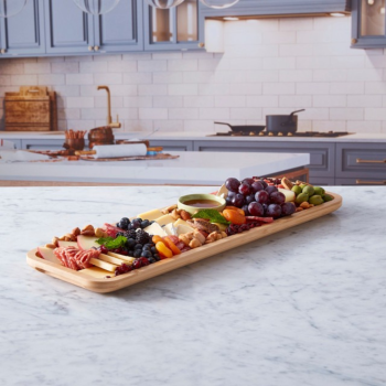 Farberware Build-a-Board Platter on a kitchen bench full of platter foods.