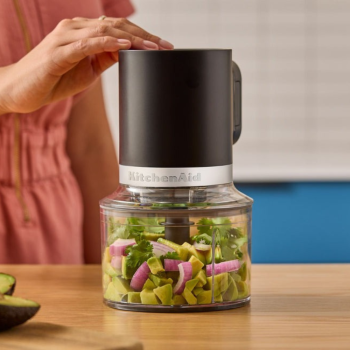 KitchenAid Go Cordless Top down Chopper bowl + lid in use on kitchen bench.